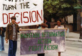 Bakke Decision Protest depicting people marching and holding protest signs in Seattle, Washington, 1977