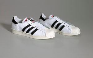 Pair of white and black Run-D.M.C. Superstar 80s sneakers made by Adidas