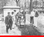 Young men with a garden tilling machine in job-training program