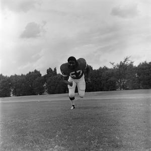 Football player running on the field, 73