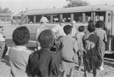 Young African Americans boarding a bus after being arrested for civil rights demonstrations in Selma, Alabama.