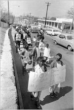 Sanitation workers strike supporters marching on Martin Luther King Jr. Drive in downtown Atlanta, Georgia, March 28, 1970. Photograph is part of a series labeled "Strike march."