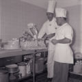 Film negative of Moulin Rouge chef Dave Nussbaum displaying a picnic basket and cake, May 23, 1955