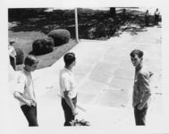 Thumbnail for Mississippi State Sovereignty Commission photograph of Richard Barrett standing on the steps of the Mississippi State Capitol between two teenage boys and looking down the walkway at a police officer and G. Garland Lyell, Jackson, Mississippi, 1967 July 30