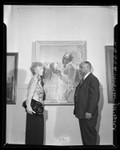 Artist Betsy Graves Reyneau and AACP president Thomas L. Griffith standing besides portrait of Dr. George Washington Carver, 1948