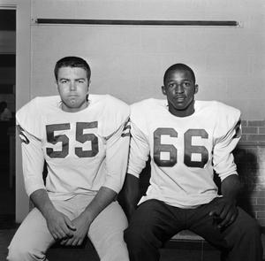 Two football players with shoulder pads, 10