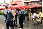 Boxes of produce being given to firemen. "We give to the community" explained the masked man in black. Red Rooster, 310 Malcolm X Blvd., Harlem