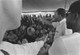 Martin Luther King, Jr., speaking at a gathering under a tent during the "March Against Fear" through Mississippi, begun by James Meredith.