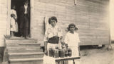 African American woman and young girl with jars of preserves in Madison County, Alabama.