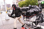 Scavenger pulling his shopping cart, Frederick Douglass at West 125th St., Harlem