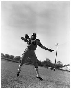 A Football Player Throwing a Football