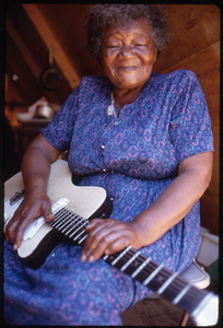 Older woman in tent playing an electric guitar, Resurrection City encampment