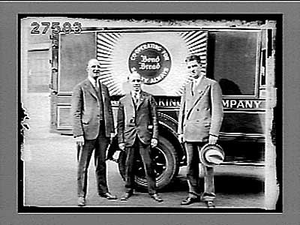 Truck with "Bond Bread" sign, and three men in suits standing beside it. Active no. 1772 : photonegative.