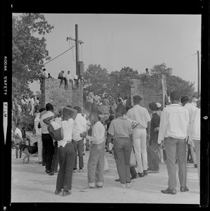 Students and other spectators standing and listening to speakers at rally in Franklin Park