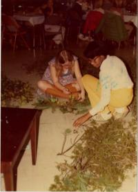 Two Individuals Working with Pine Boughs