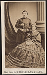 [Major General George Brinton McClellan of General Staff U.S. Volunteers Infantry Regiment, in uniform standing beside his wife, Mary Ellen McClellan, in front of painted backdrop]