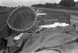 Trailer full of cotton being pulled by a tractor down a paved road near Mount Meigs in Montgomery County, Alabama.