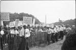 [Marshals standing by fence near crowd carrying signs, including "Baptist Ministers Conference of Washington &amp; Vicinity" and "We March for First Class Citizenship Now," during the March on Washington, 1963]