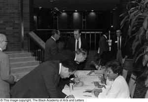 Photograph of unidentified people sitting at a table