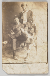 Photographic postcard of three unidentified men