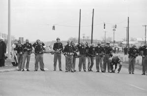 Alabama state troopers in gas masks and riot gear, waiting for civil rights marchers on the south side of the Edmund Pettus Bridge in Selma, Alabama, on Bloody Sunday.