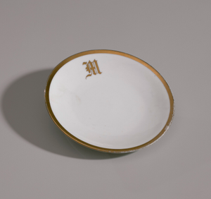 White plate with gold trim from Mae's Millinery Shop