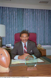 Photograph of Pettis Norman seated at his desk #2