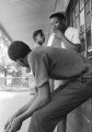 Willie Smith, James "Pistol" Wilson, and Lucius Gantt on the front porch of Pugh's Superette on Foster Street in Newtown, a neighborhood in Montgomery, Alabama.