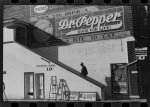 Negro going in colored entrance of movie house on Saturday afternoon, Belzoni, Mississippi Delta, Mississippi