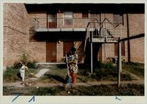 Rilene and Chasity Dixon clean up the lawn in front of their East Lake Meadows apartment, October 28, 1992