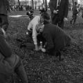 Police officers and two other men restraining a civil rights demonstrator on the ground during a protest at Kelly Ingram Park in Birmingham, Alabama.