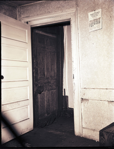 Interior of house with open doorway, Pittsburgh: black-and-white photonegative.