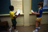 Unidentified student and Joshua Carlebach reading in class