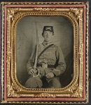 [Private David M. Thatcher of Company B, Berkeley Troop, 1st Virginia Cavalry Regiment, in uniform and Virginia sword belt plate with Adams revolver and cavalry sword]