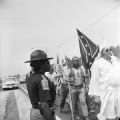 Officer Clara Zeigler observing a Ku Klux Klan march on Highway 80 outside of Selma, Alabama.