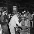 Students watching a blacksmith work in Westville, a nineteenth-century living history village in Lumpkin, Georgia.