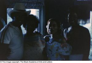 Dark photograph of a Tony Dorsett, Mollie Williams and two other individuals