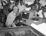 Bennie D. Lambert, disc jockey from radio station WRMA in Montgomery, Alabama, playing records at Dozier's Radio Service on West Jeff Davis Avenue.