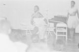 Woman demonstrating a traditional African dance in a gymnasium, probably in Montgomery, Alabama..