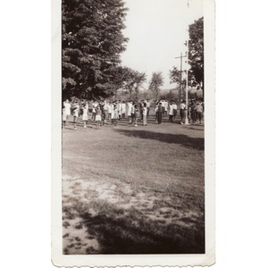 A group of campers salutes the American flag at Breezy Meadows Camp