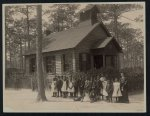 [Africian American school children posed with their teacher outside a school, possibly in South Carolina]