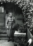 Resident in front of World War II-era housing in Marin City, California, circa 1960 [photograph]