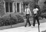 Two men walking on sidewalk at Duke University.