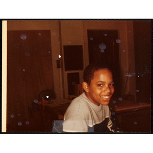 An African American boy smiles for the camera during a class at the Boys & Girls Club