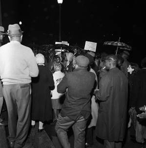 Demonstrators in the rain at a voter registration rally outside the Jefferson County courthouse in Birmingham, Alabama.