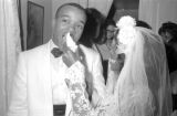 Susie Sanders Hubbard feeding cake to her new husband, Freddie, during their wedding reception in her parents' home in Montgomery, Alabama.