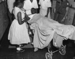 Fred Shuttlesworth on a stretcher at Hillman Hospital, where he was taken after Klansmen beat him while he was trying to enroll his daughters in the all-white Phillips High School.