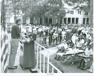 Thumbnail for Photograph of Georgia governor Jimmy Carter speaking at a podium to a large gathering of patients, staff, and local residents at the Georgia Warm Springs Foundation, Warm Springs, Meriwether County, Georgia, 1971-1975?