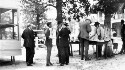 Unidentified group of men eating watermelon