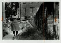 Pinkie North, walking near her Herndon Homes apartment, undated